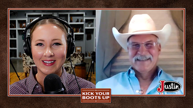 A woman with blonde hair and an older man with gray hair and a cowboy hat looking at the camera, smiling, sitting, and having a conversation.